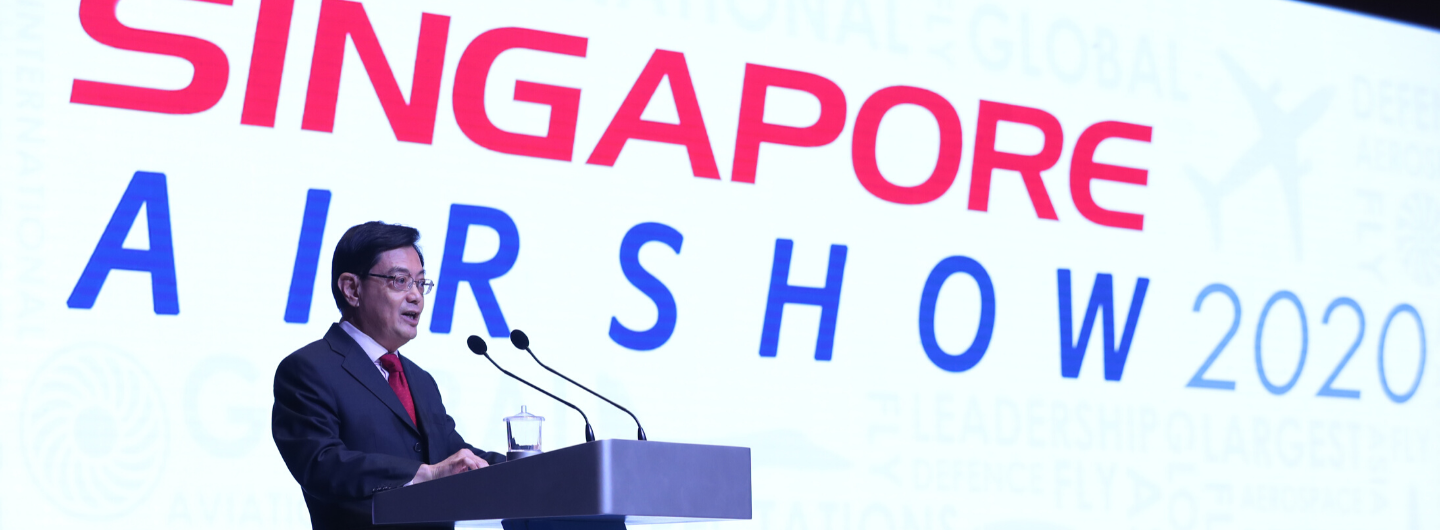 Man at podium with "Singapore Airshow 2020" backdrop.